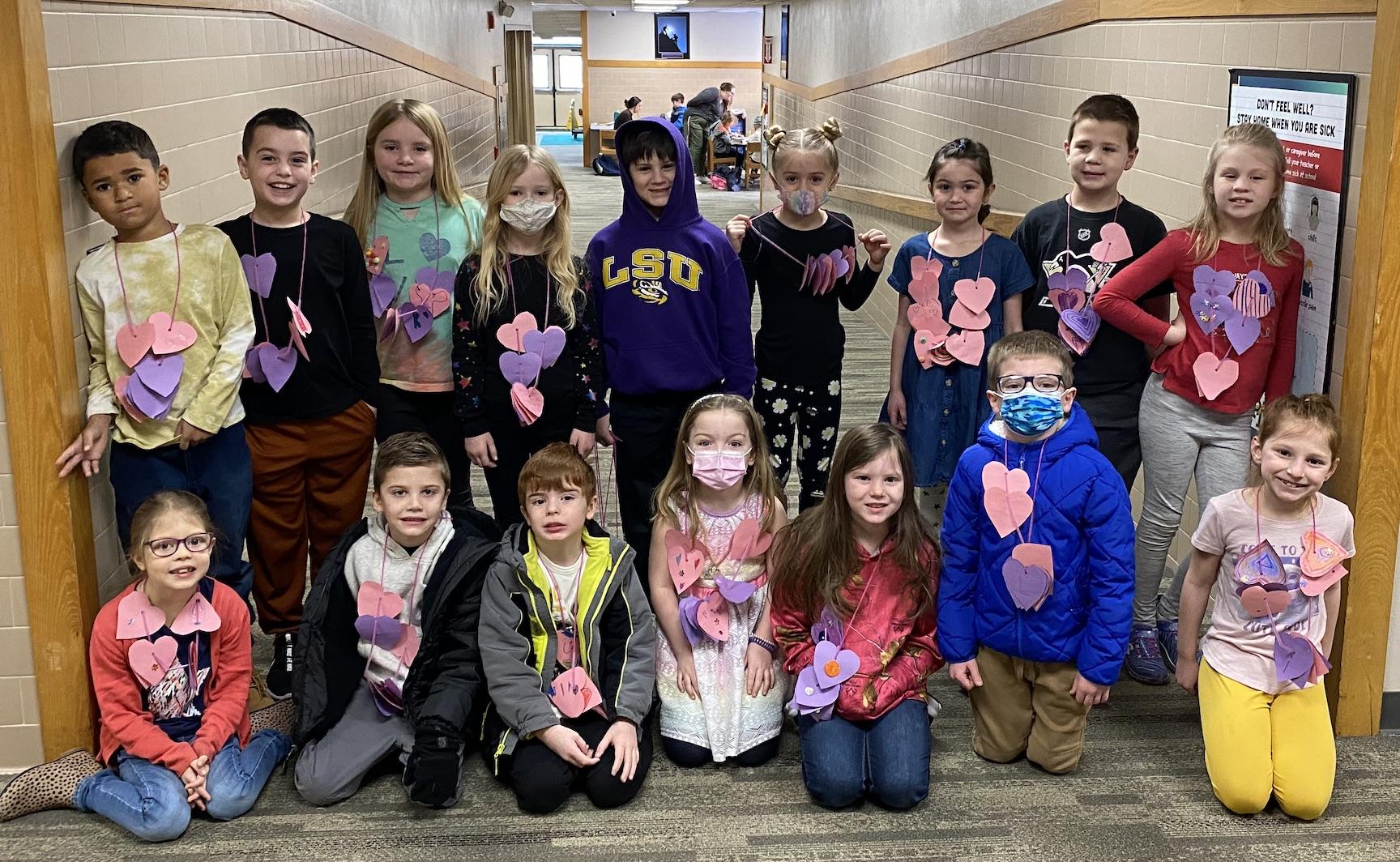 Kindergarten, first and second graders show off their heart necklaces