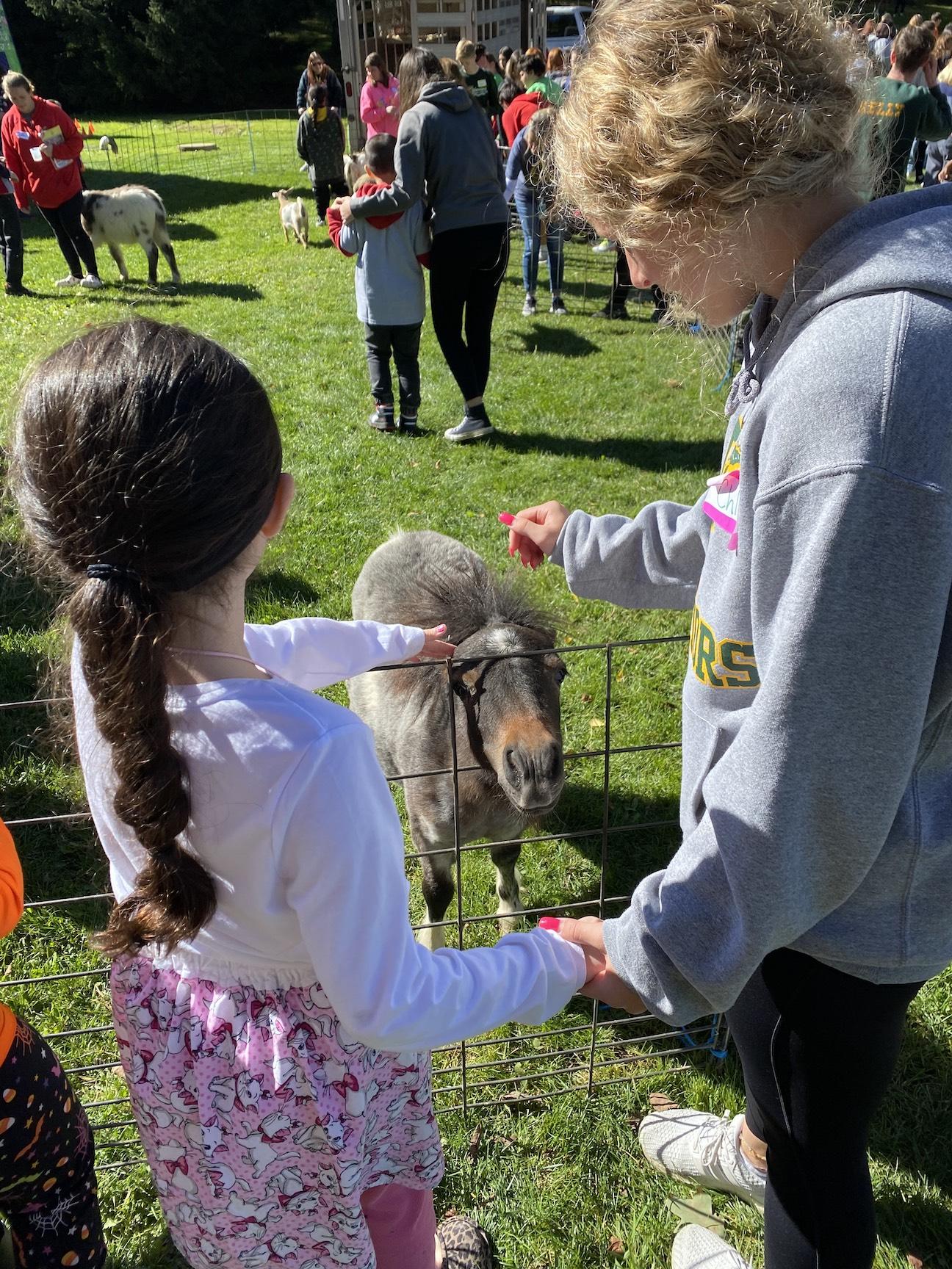 Izzy Parrendo (grade 4) and her buddy enjoy the petting zoo