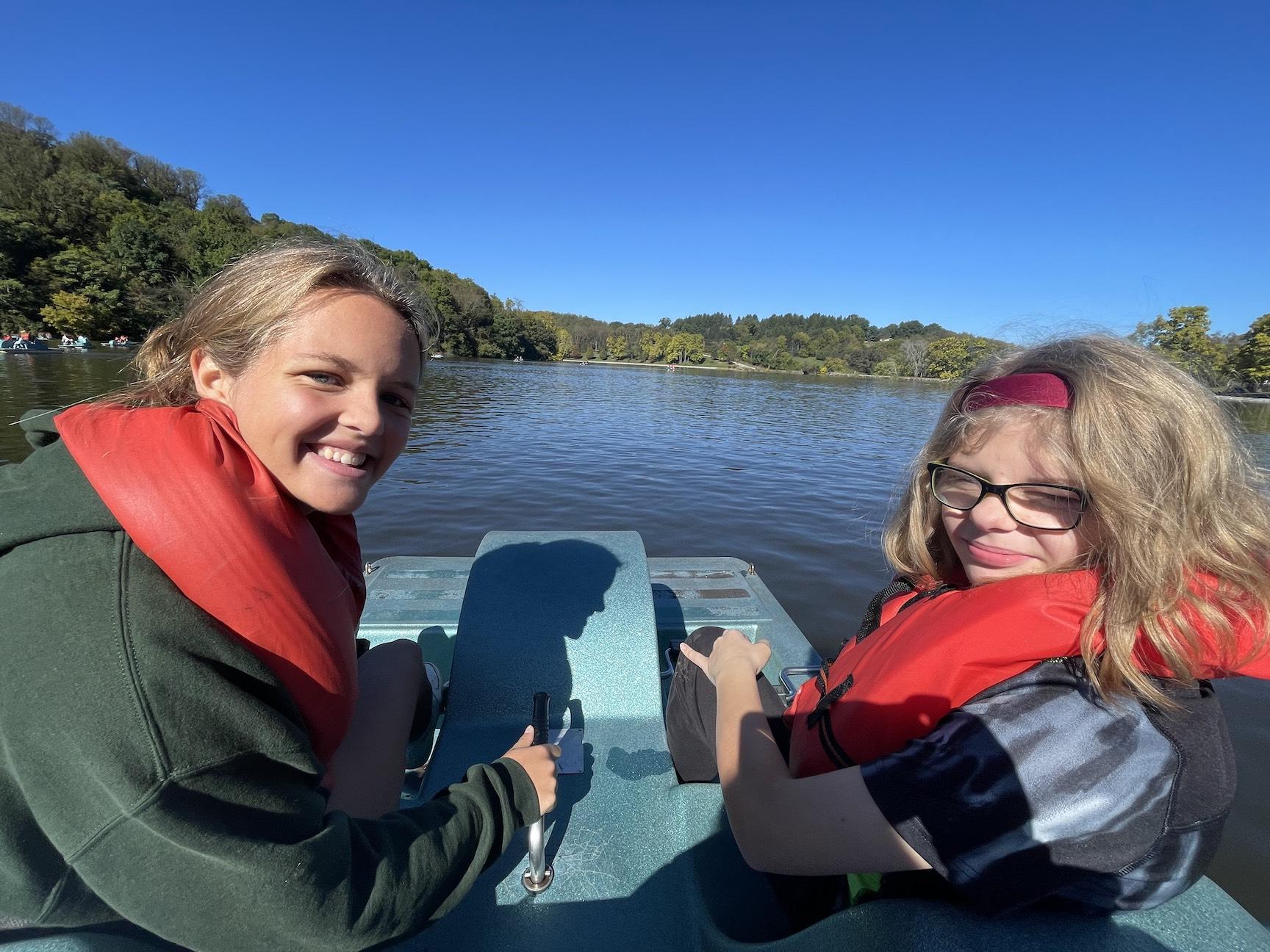 Fourth-grader Jackie LeCuyer (right) and her buddy take a boat ride