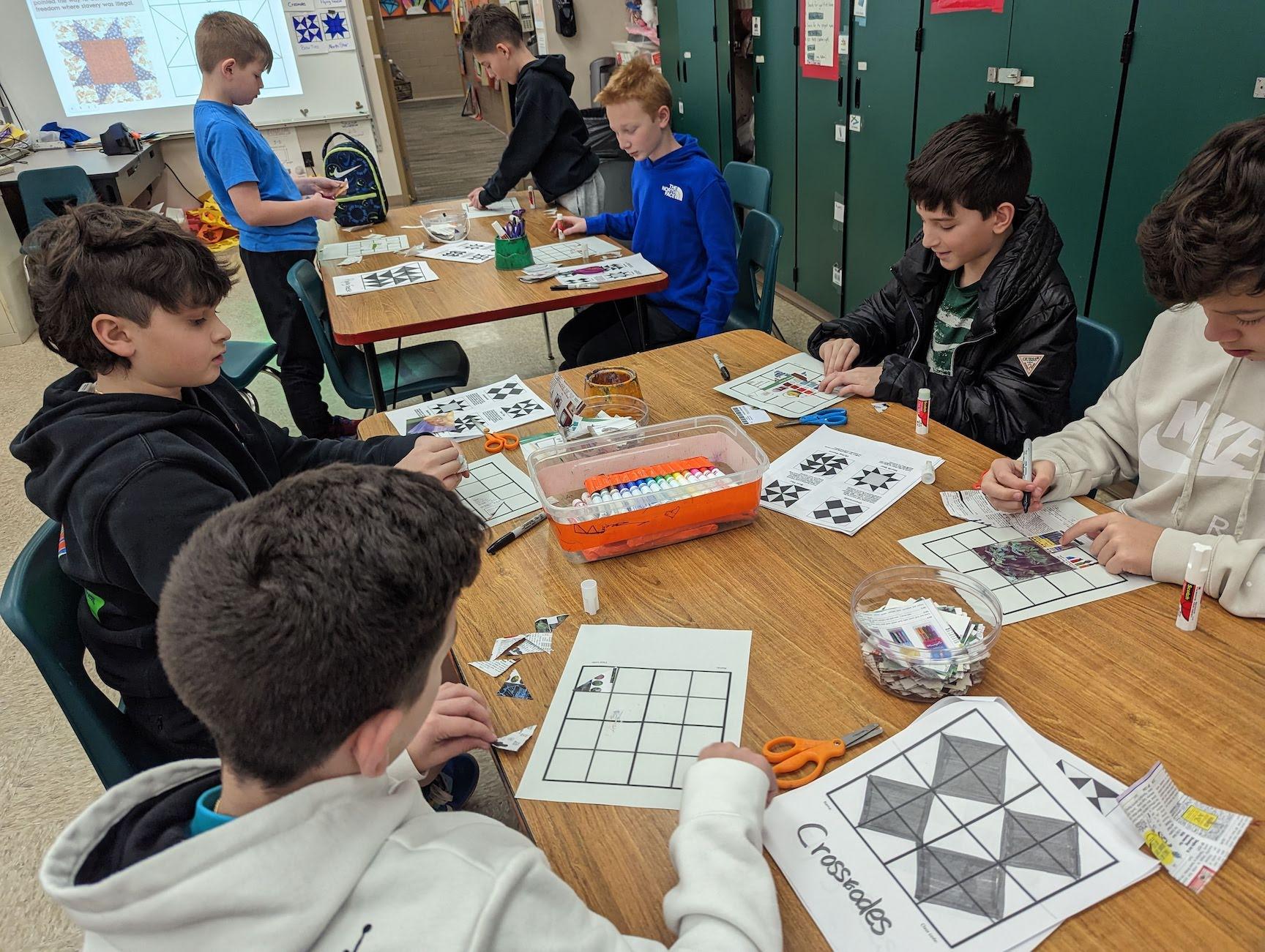 Level Green 5th and 6th-graders Aiden Crawford, Maddox Abbott-Foreback, Miles Johnson, Nathan Goldberg, Antonio Caruso, Sloan Simpson, and Jackson Carr create a collage quilt using grids