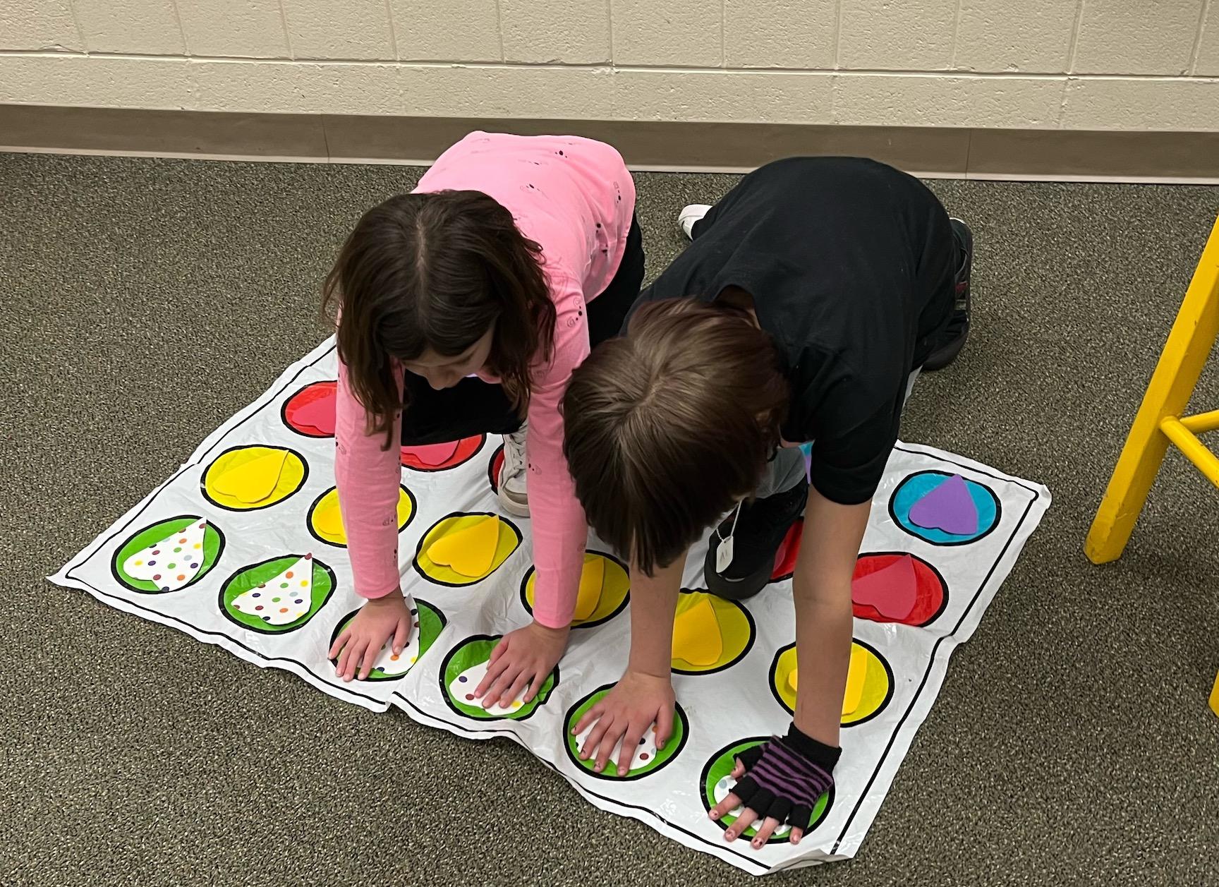 At Trafford Elementary, 2nd-graders Brooklyn Bost and Ares Lyle play a game of Heart Twister