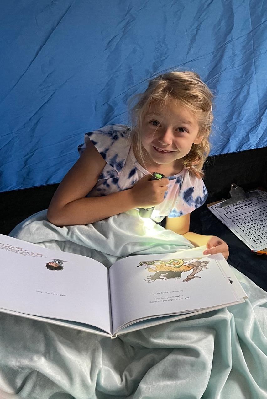 Savannah Metz enjoys some reading time in the tent