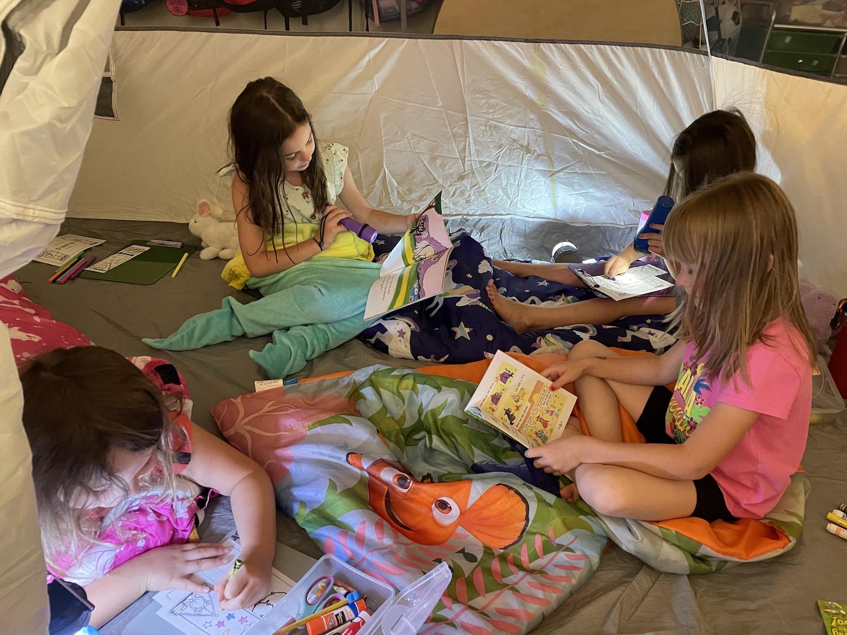 Students gather in the tent with their favorite books