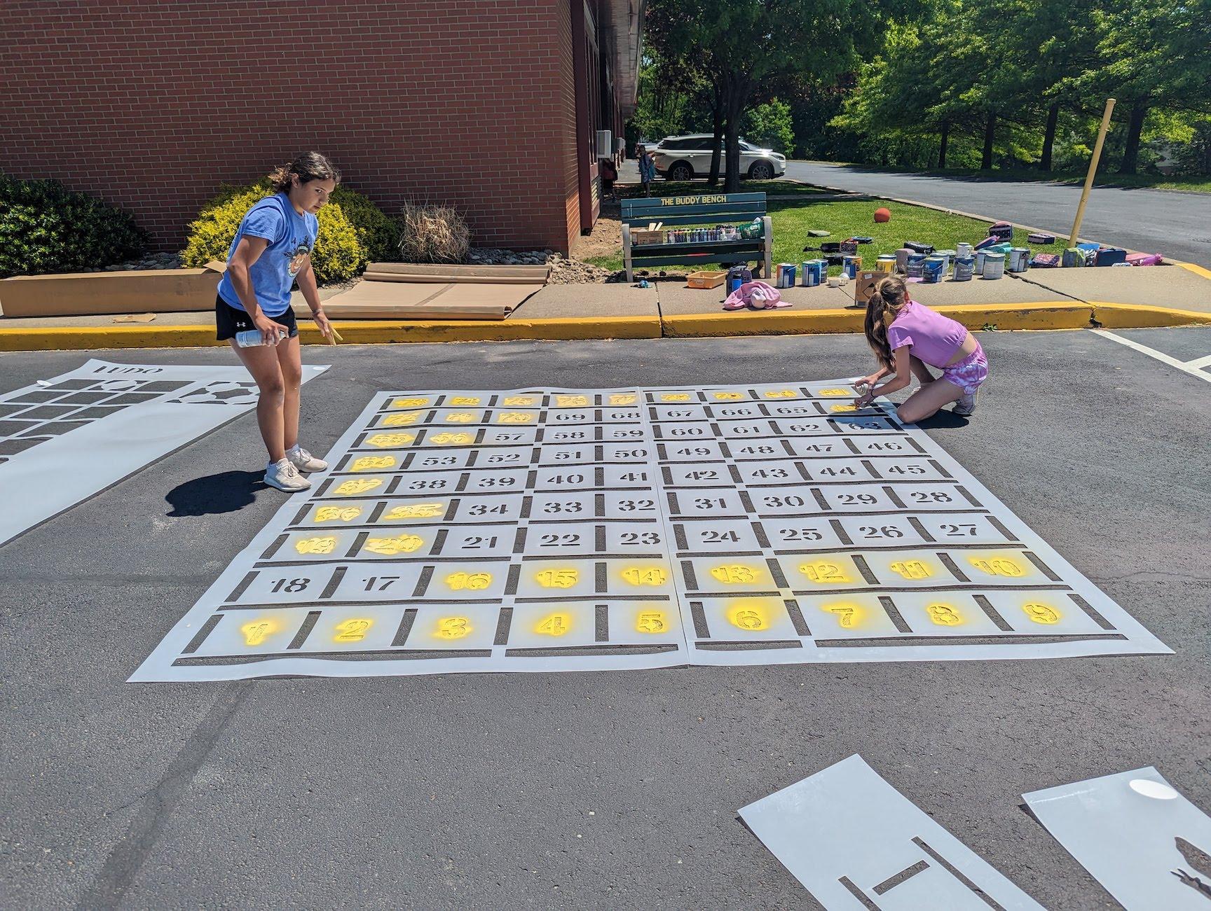 Students use a template to create the sidewalk game