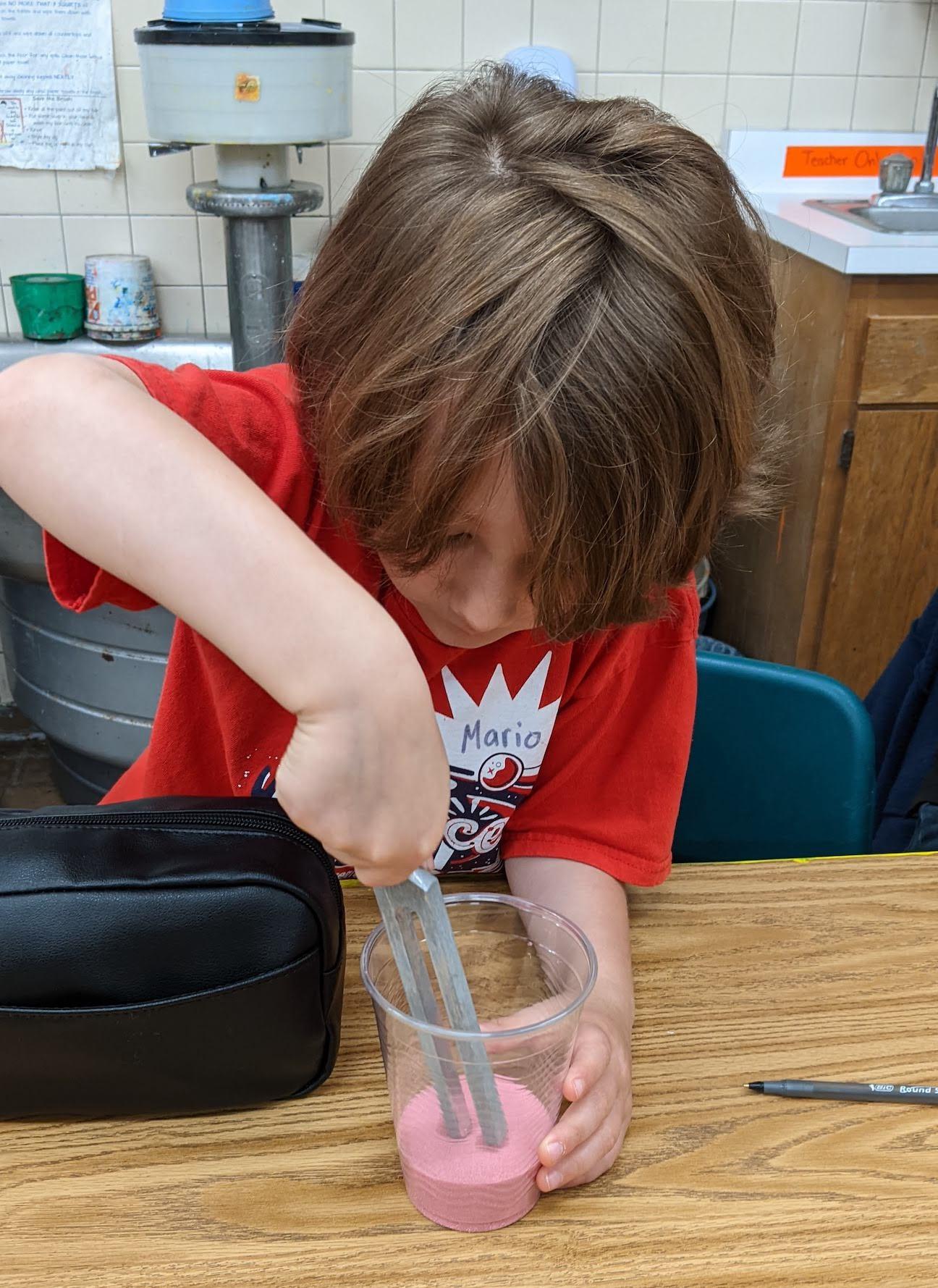 Third-grader Mario Spino sent sound vibrations through sand to see the invisible soundwaves