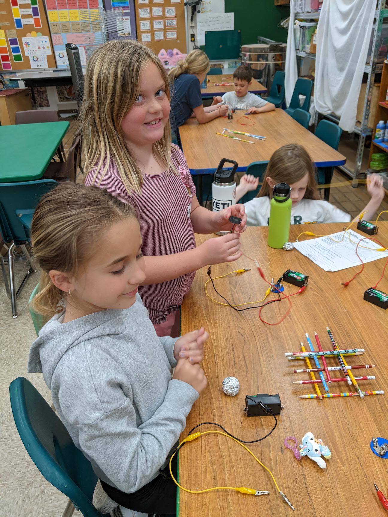 Macie Seneca (grade 4) and Hayley Cheripka (grade 5) build circuits using a schematic diagram