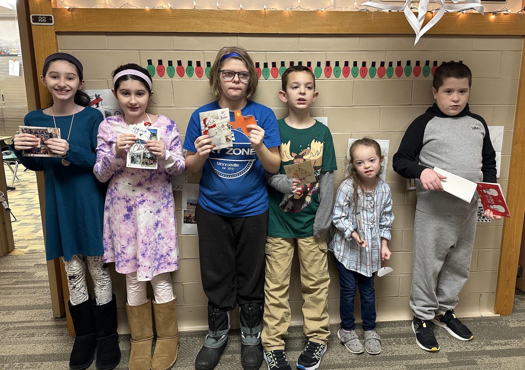 Nina Parrendo, Izzy Parrendo, Jackie LeCuyer, Kyle Hilgert, Charlotte Teoli, and Alex Ginsburg hold some of the cards they received in the mail