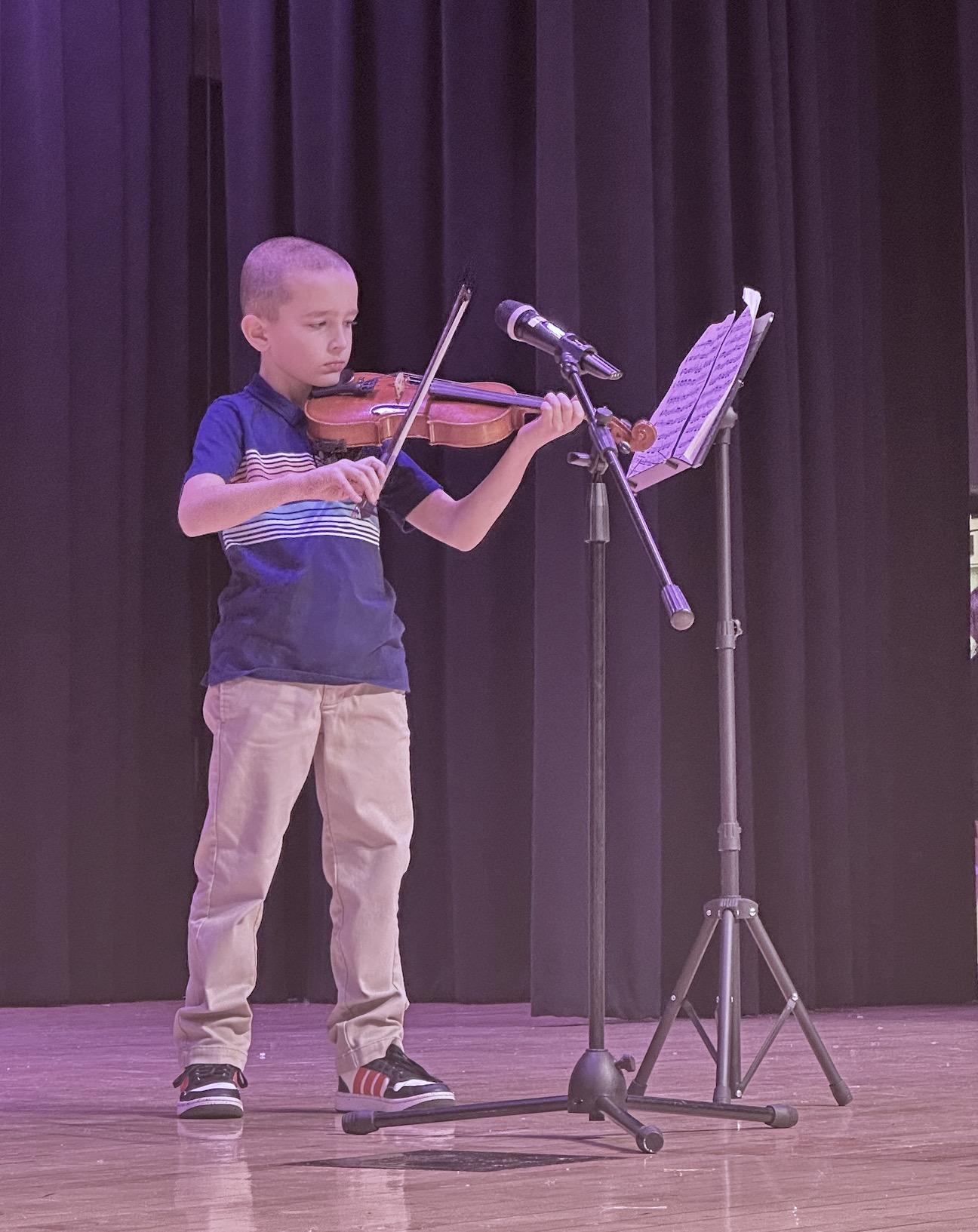 3rd-grader Roman Schnauber played the violin